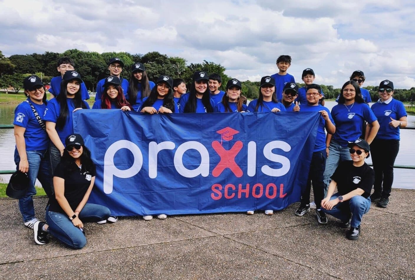 Estudiantes con la bandera de Praxis School en un parque de Bogotá